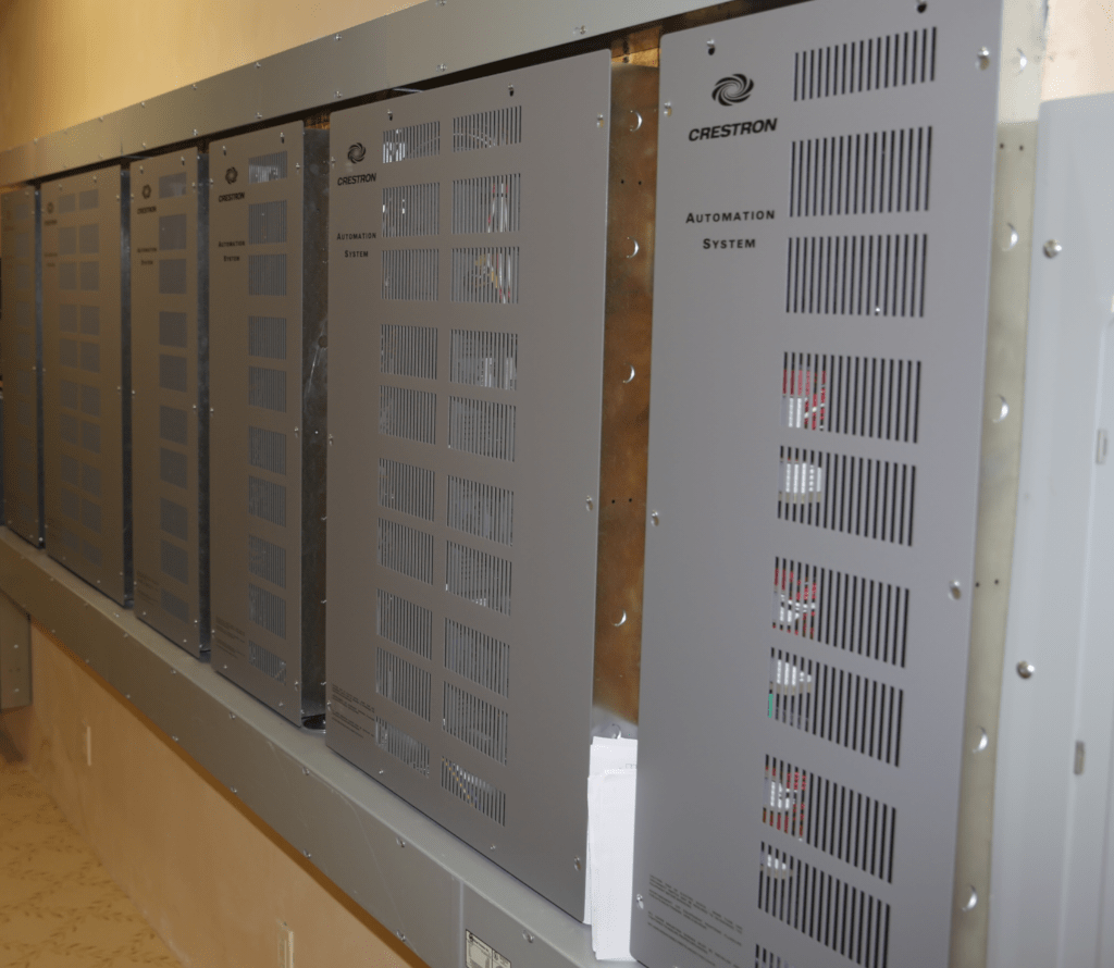 A row of metal electrical panels mounted on a wall.